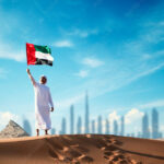 arab man holding the uae flag in the desert celebrating uae national day and uae flag day stockpack adobe stock| وظائف شركة مؤتمن بمختلف التخصصات في الامارات